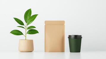 A plant, a brown paper bag, and a green coffee cup are on a white table photo