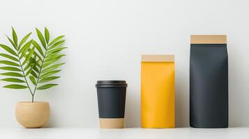Three coffee cups and two bags of coffee sit on a white table photo