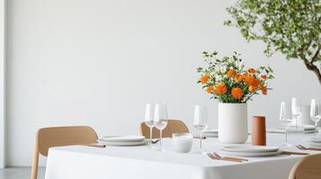 A table with a vase of flowers and a white tablecloth photo