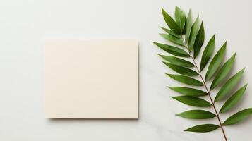 A minimal white card with a green leaf on top of it photo