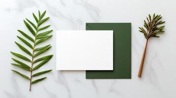 A white card with a green border sits on a table with a leaf and a green stem photo