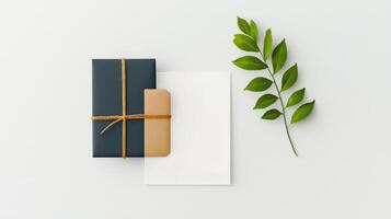 A black box with a white card and a leaf on top photo