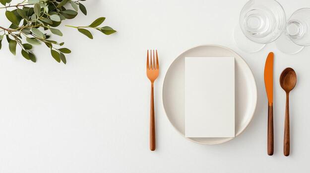 A minimal style white plate with a fork, knife, and spoon on it photo