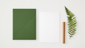 A green envelope sits on a white background with a leaf and a wooden pencil photo