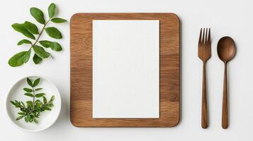 A wooden tray with a white napkin and a fork and spoon on it photo