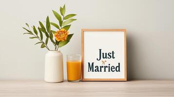 A vase with a flower and a glass of orange juice sits on a table photo