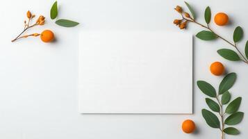 A white piece of paper with a few oranges and leaves on it photo