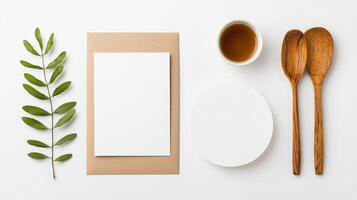 A white paper with a leaf on it and a spoon and a cup of tea photo