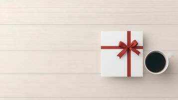 A white box with a red bow on top of a wooden table photo