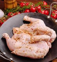 Preparing marinated chicken with fresh herbs and vegetables photo