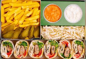 Delicious wraps with fries and sides at a casual dining location photo