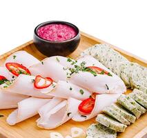 Fresh and vibrant platter featuring assorted cold cuts and herbs photo