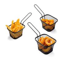 Three serving baskets with various fried snacks on a table photo