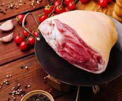 Fresh cut of meat arranged on a wooden table with spices photo