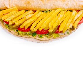 Delicious sandwich with fries, tomatoes, and pickles on a flatbread photo