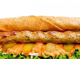 Delicious sandwich featuring grilled kebab and fresh toppings photo