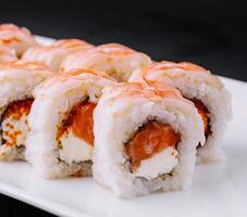 Fresh sushi roll platter on black background photo