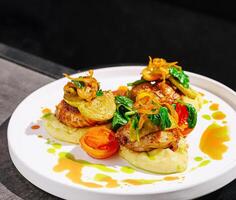 Delicious dish of grilled chicken served with fresh vegetables photo