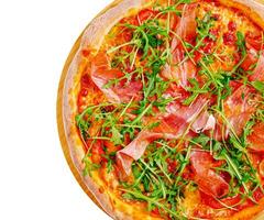 Delicious pizza topped with prosciutto and arugula on wooden board photo