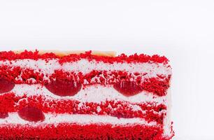 Red velvet cake with layers of cream and cherries on display photo