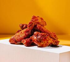Spicy chicken wings in a bright box backdrop photo