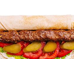 Delicious kebab wrap filled with fresh vegetables and sauces photo