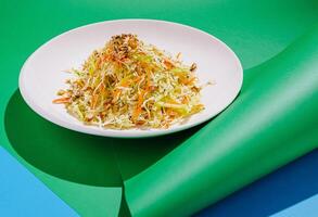 Fresh vegetable salad with nuts served on a colorful plate photo