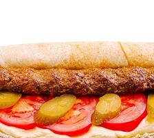 Delicious meat sandwich with fresh vegetables and condiments photo