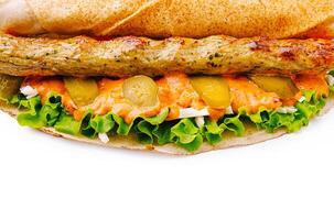 Freshly made sandwich with greens and grilled chicken sausage photo