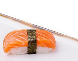 Fresh sushi with salmon topping served on a clean plate photo