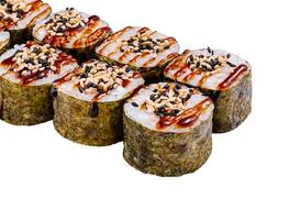 Sushi rolls with unagi sauce and sesame seeds on white photo