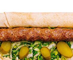 Delicious kebab roll with fresh toppings and flavored sauce photo