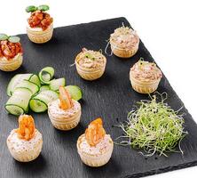 Delicious seafood appetizers displayed on a slate platter closeup photo