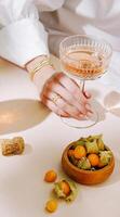 Elegant gathering with sparkling drink and fresh fruit on table photo