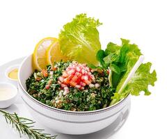 Fresh salad with herbs, greens, and citrus in a bowl photo
