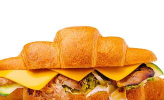 Delicious croissant sandwich filled with cheese and grilled chicken photo