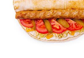 Delicious sandwich with meats, vegetables, and cheese on display photo