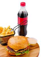 Delicious burger served with fries and a cold beverage photo
