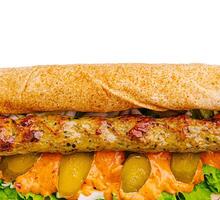 Delicious sandwich featuring skewered meat and fresh vegetables photo
