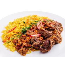 Savory beef and rice dish garnished with vegetables and herbs photo