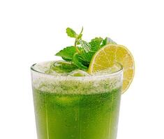 Refreshing green drink with mint and lime served in a glass photo