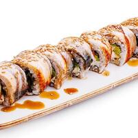 Sushi roll served on a plate with sesame and sauce drizzle photo