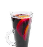 Warm beverage with citrus and fruit slices in a glass cup photo