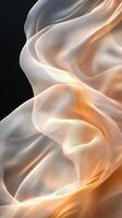 Elegant flowing sheer fabric in warm golden hues on dark background photo