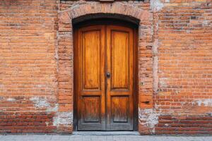 Rustic wooden door set in brick wall architecture.. photo