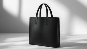 A black tote bag sitting on a table photo