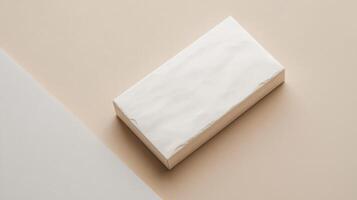 A white block of soap sitting on top of a beige background photo