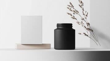 A black bottle and a white box on a white surface photo