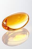 Golden gel capsule resting on smooth white surface, capturing soft diffused light with high detail photo