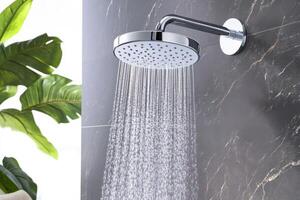 Luxurious rainfall showerhead mounted on sleek black marble wall with soothing water cascade in a serene spa-like atmosphere photo